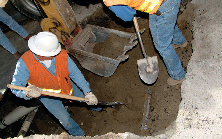 Construction workers digging