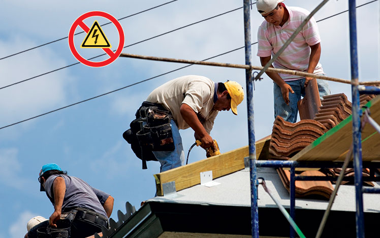 Workers On Roof Near Overhead Power Lines